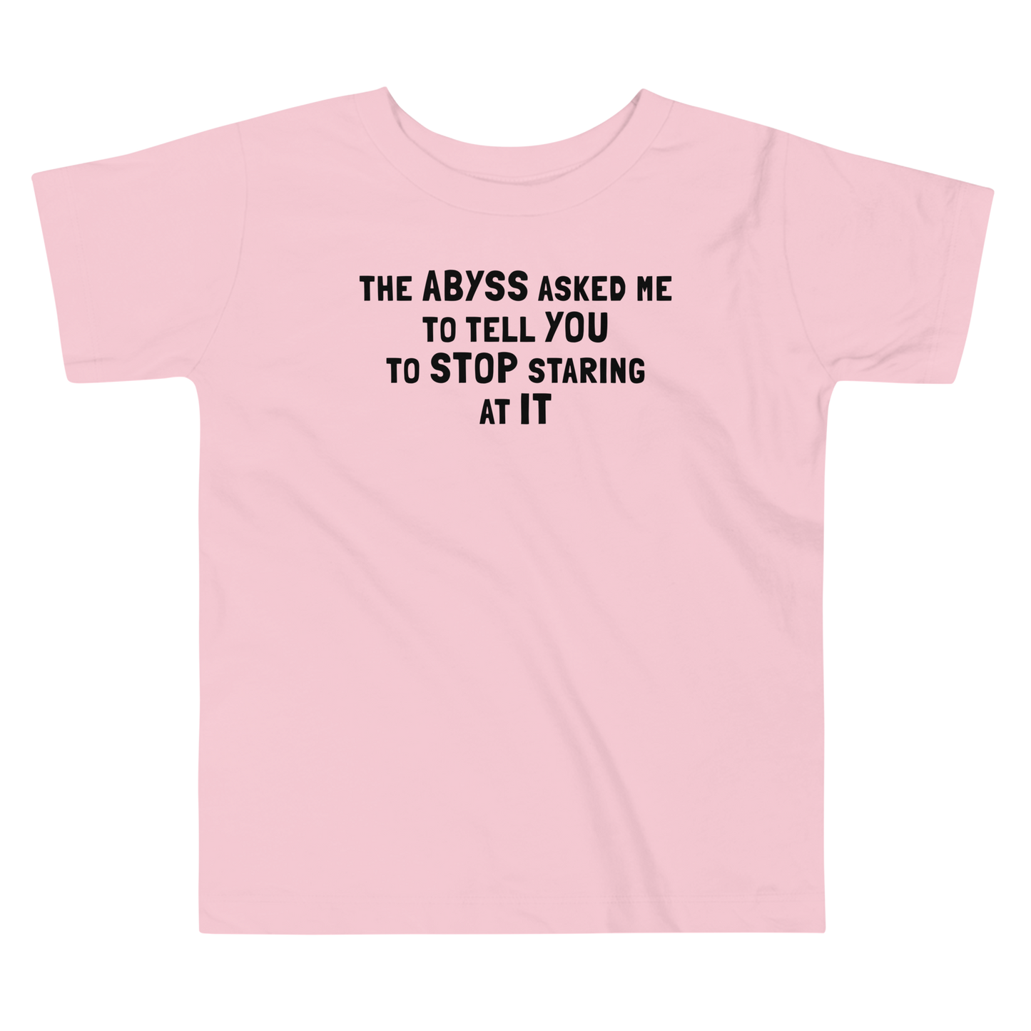 "The Abyss asked me to tell you to stop staring at it" printed on a pink toddler short sleeve tee laying on a flat surface