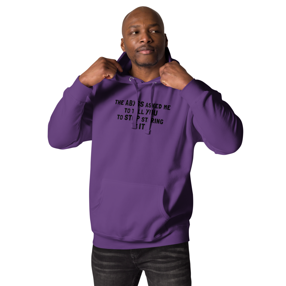 "The Abyss asked me to tell you to stop staring at it" printed on a purple unisex hoodie worn by a male