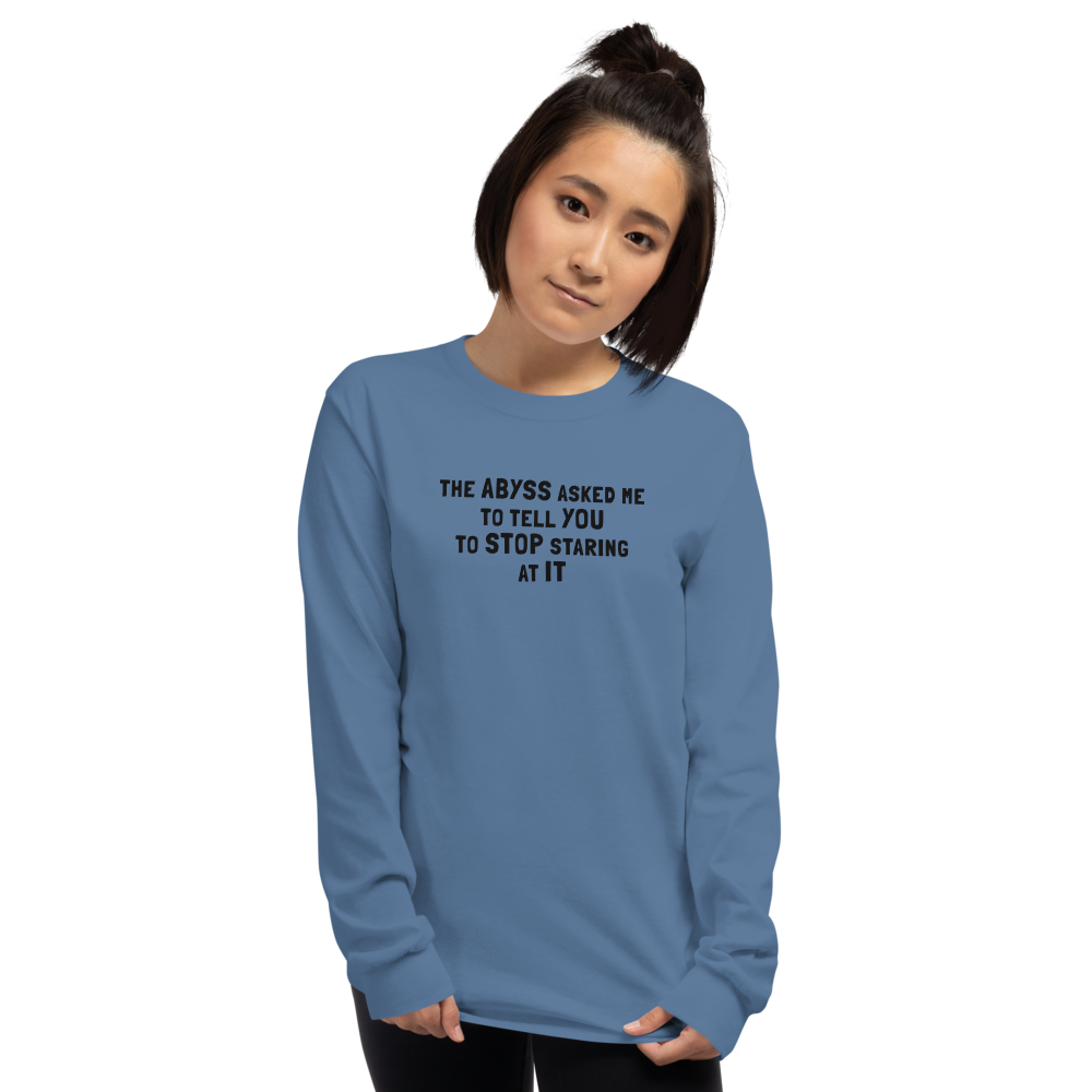 "The Abyss asked me to tell you to stop staring at it" printed on a indigo blue men's long sleeve shirt worn by a female