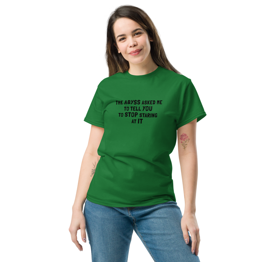 "The Abyss asked me to tell you to stop staring at it" printed on a turf green unisex classic tee worn by a female