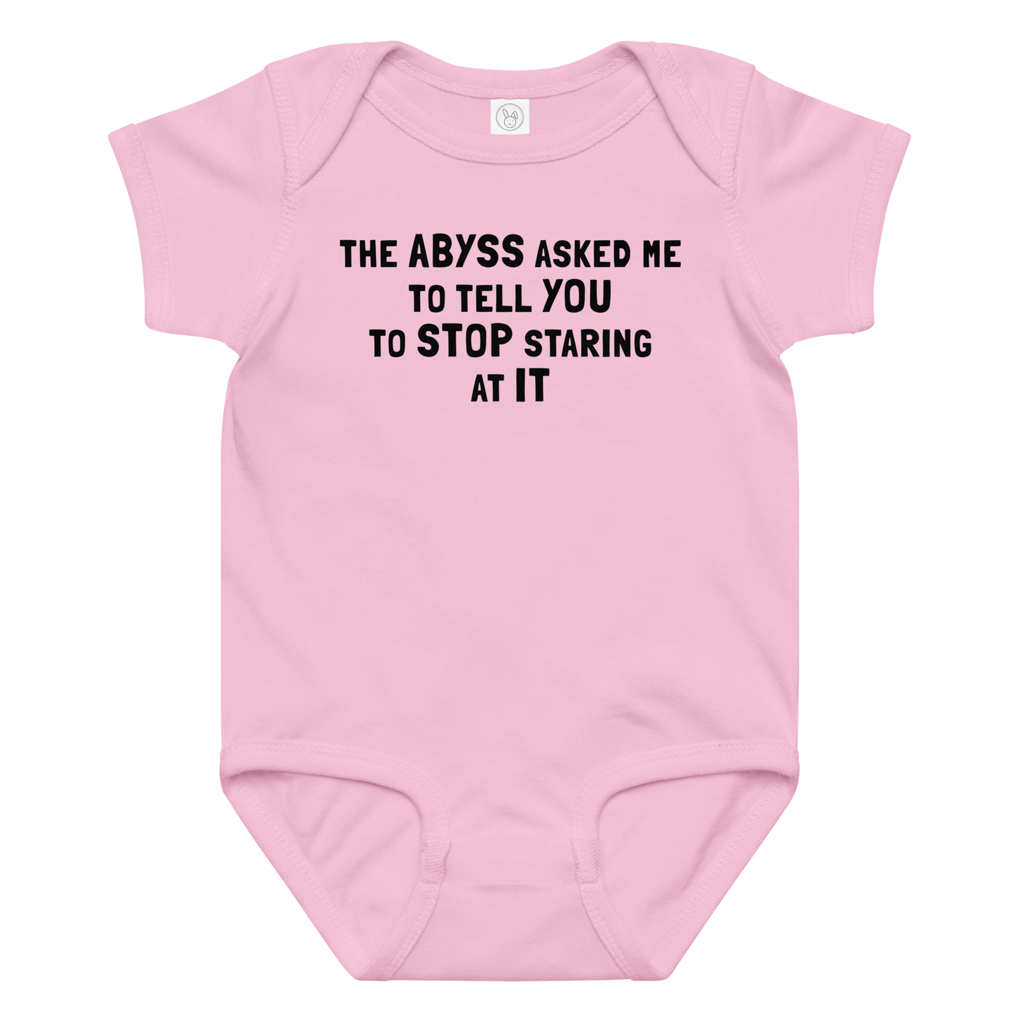 "The Abyss asked me to tell you to stop staring at it" printed on a pink baby jersey bodysuit laying on a flat surface amongst other clothes