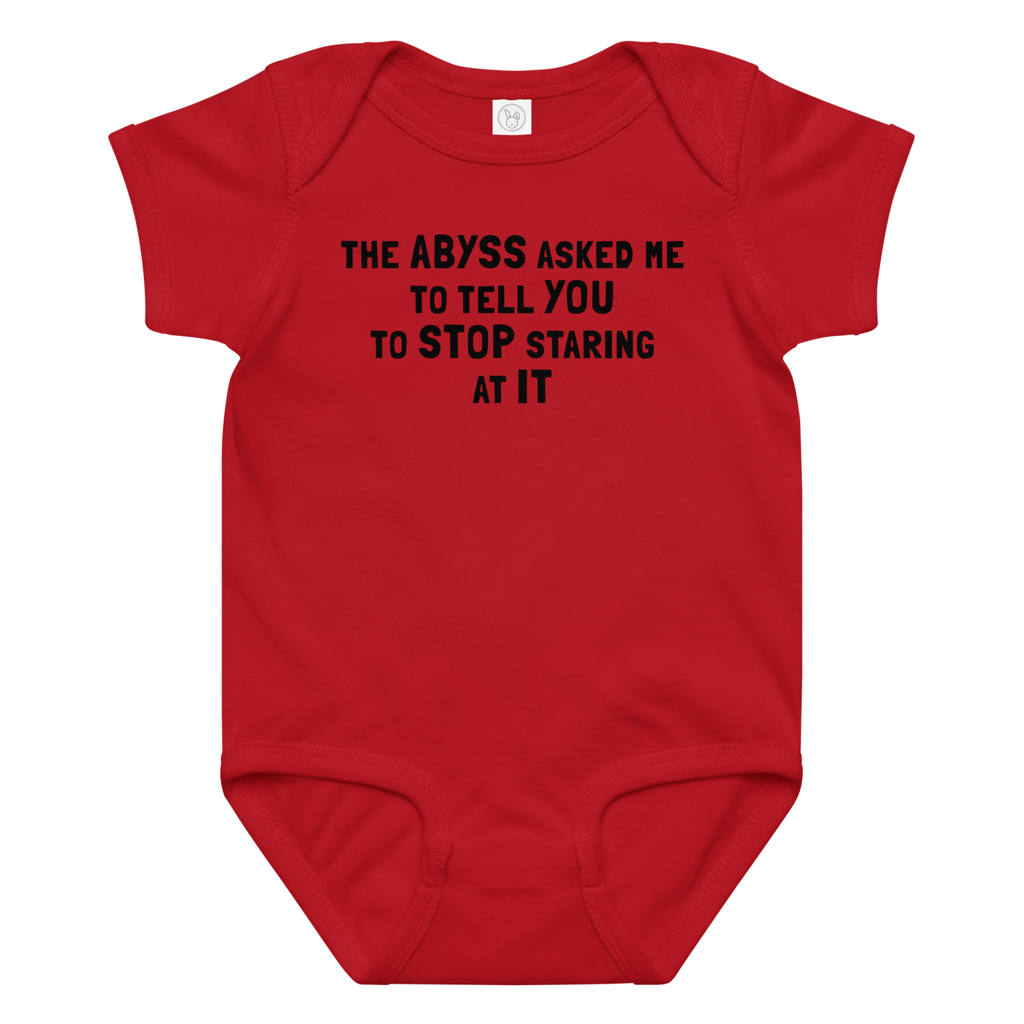 "The Abyss asked me to tell you to stop staring at it" printed on a red baby jersey bodysuit laying on a flat surface amongst other clothes