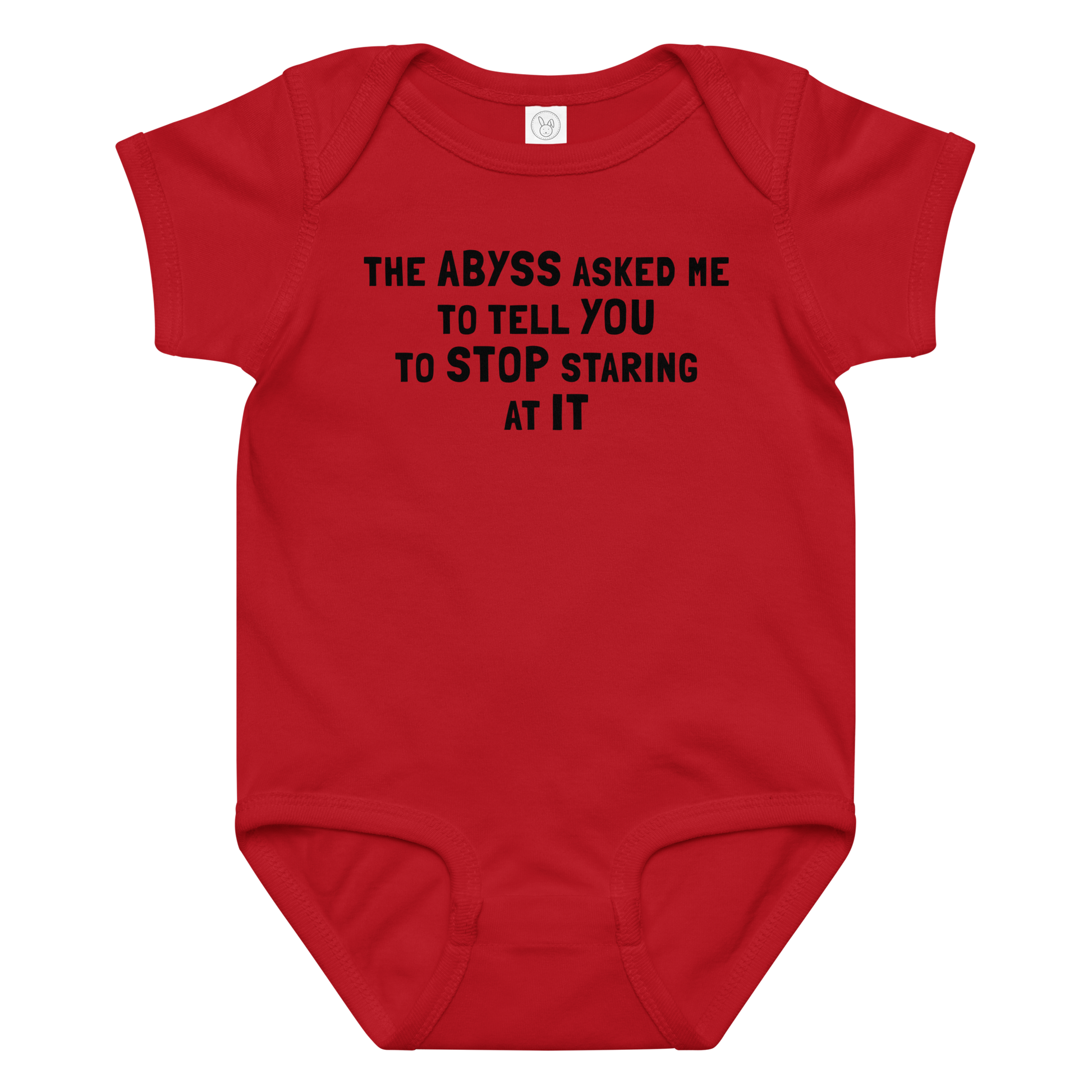 "The Abyss asked me to tell you to stop staring at it" printed on a red baby jersey bodysuit laying on a flat surface amongst other clothes
