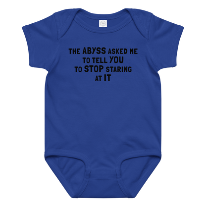 "The Abyss asked me to tell you to stop staring at it" printed on a royal baby jersey bodysuit laying on a flat surface amongst other clothes