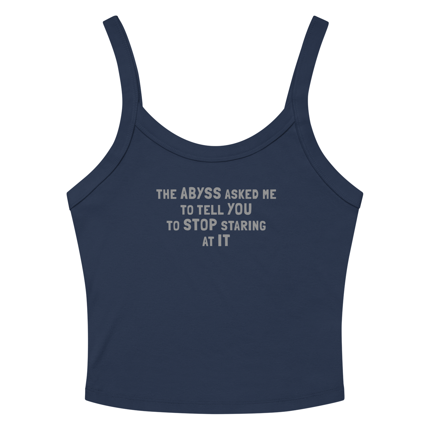 "The Abyss asked me to tell you to stop staring at it" printed on a solid navy blend women's micro-rib tanktop laying on a flat surface amongst sunglasses and shorts