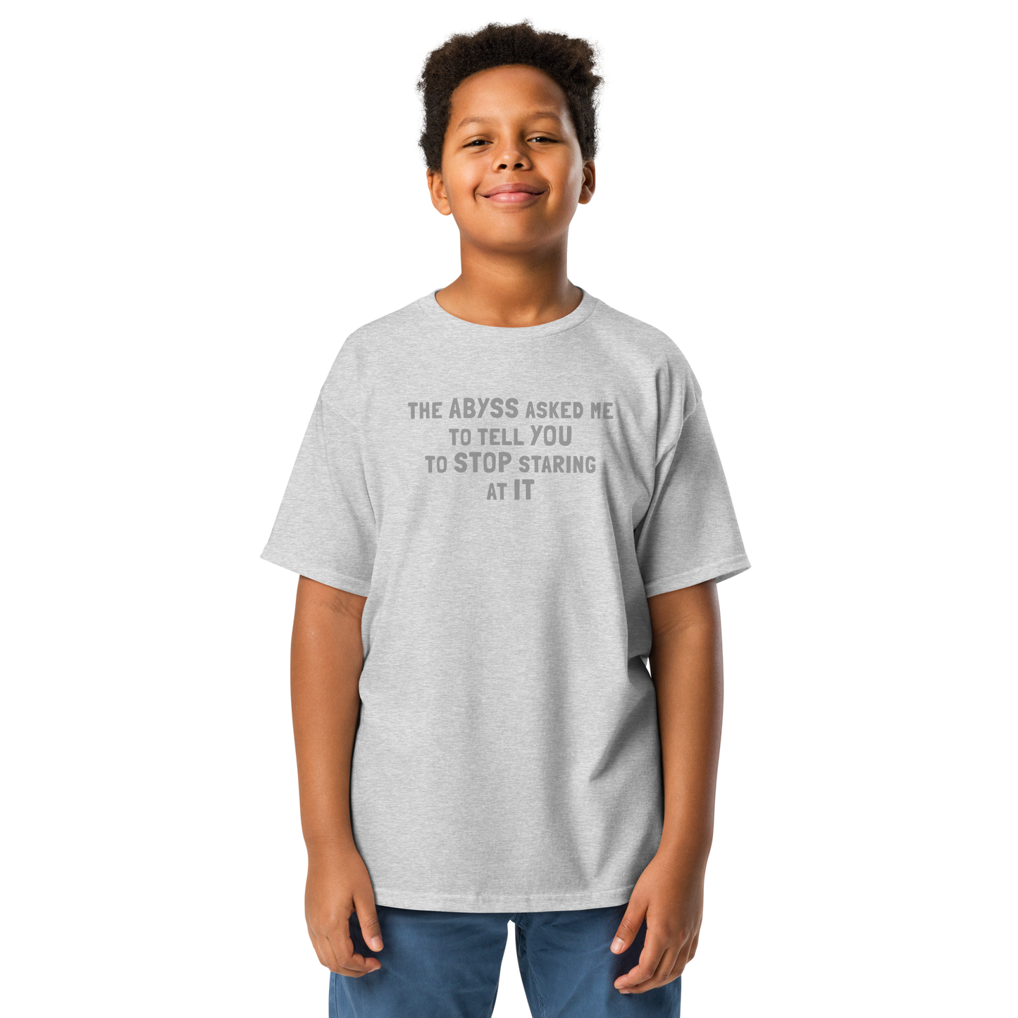 "The Abyss asked me to tell you to stop staring at it" printed on a sport grey youth classic tee worn by a male