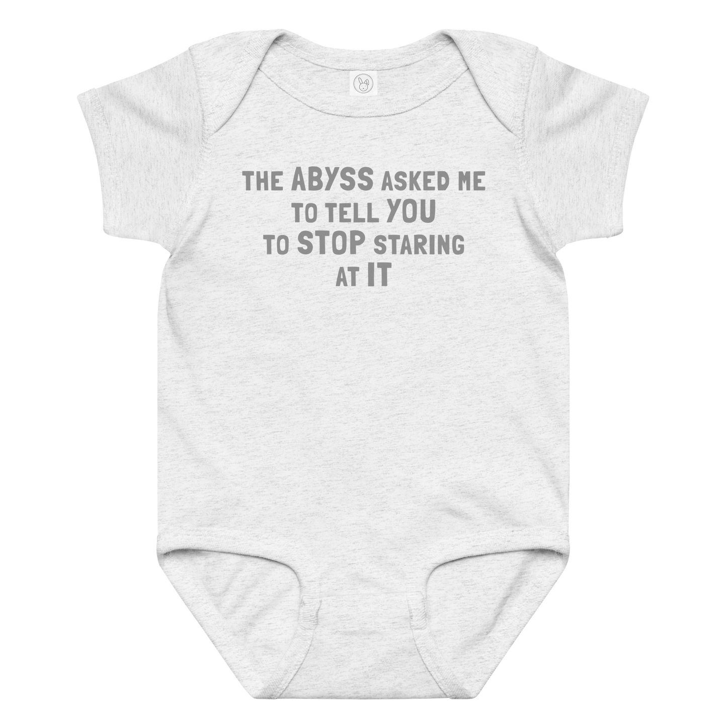 "The Abyss asked me to tell you to stop staring at it" printed on a ash baby jersey bodysuit laying on a flat surface amongst other clothes