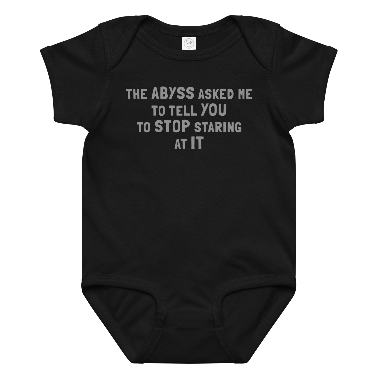 "The Abyss asked me to tell you to stop staring at it" printed on a black baby jersey bodysuit laying on a flat surface amongst other clothes
