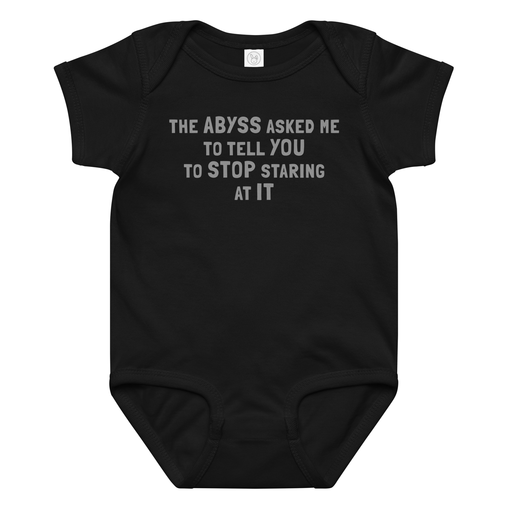 "The Abyss asked me to tell you to stop staring at it" printed on a black baby jersey bodysuit laying on a flat surface amongst other clothes