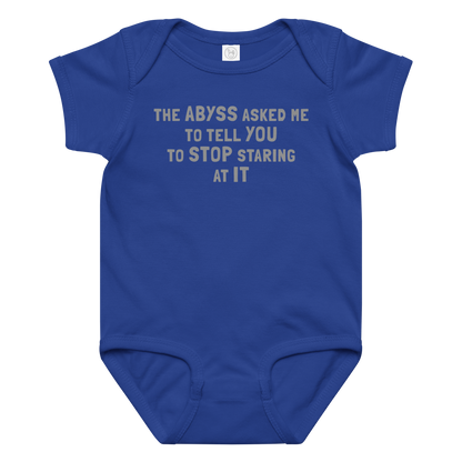 "The Abyss asked me to tell you to stop staring at it" printed on a royal baby jersey bodysuit laying on a flat surface amongst other clothes