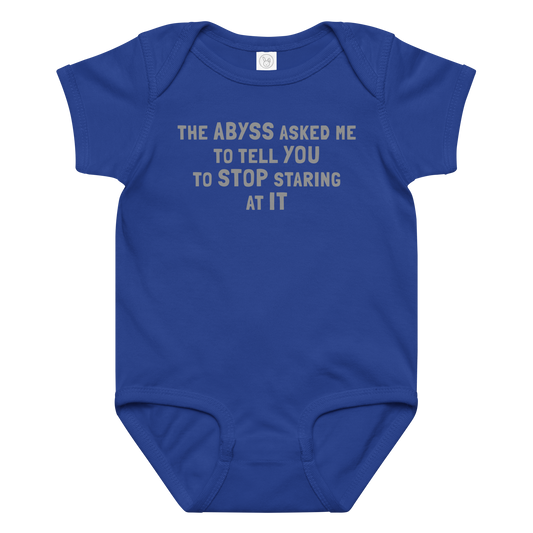 "The Abyss asked me to tell you to stop staring at it" printed on a royal baby jersey bodysuit laying on a flat surface amongst other clothes