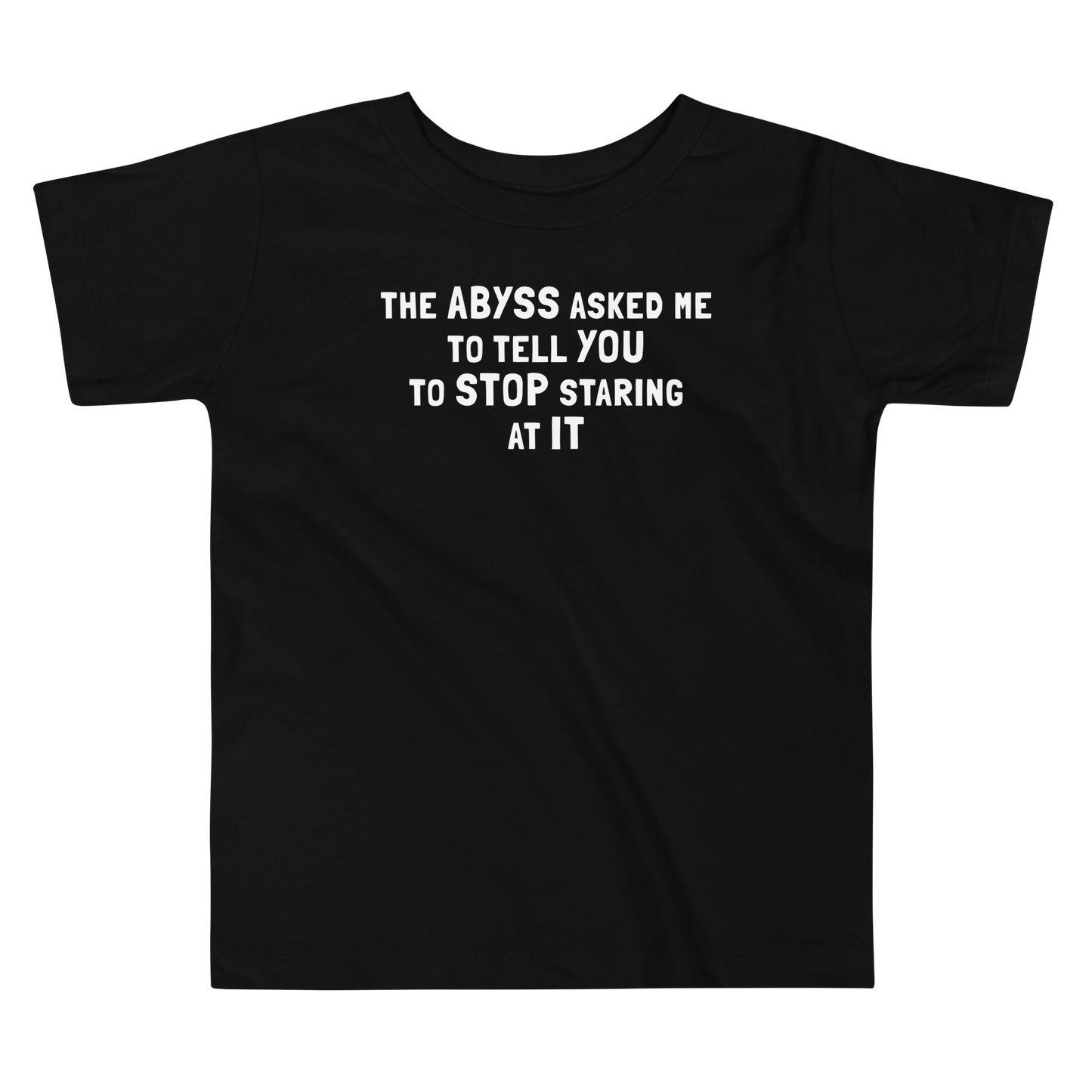 "The Abyss asked me to tell you to stop staring at it" printed on a black toddler short sleeve tee laying on a flat surface