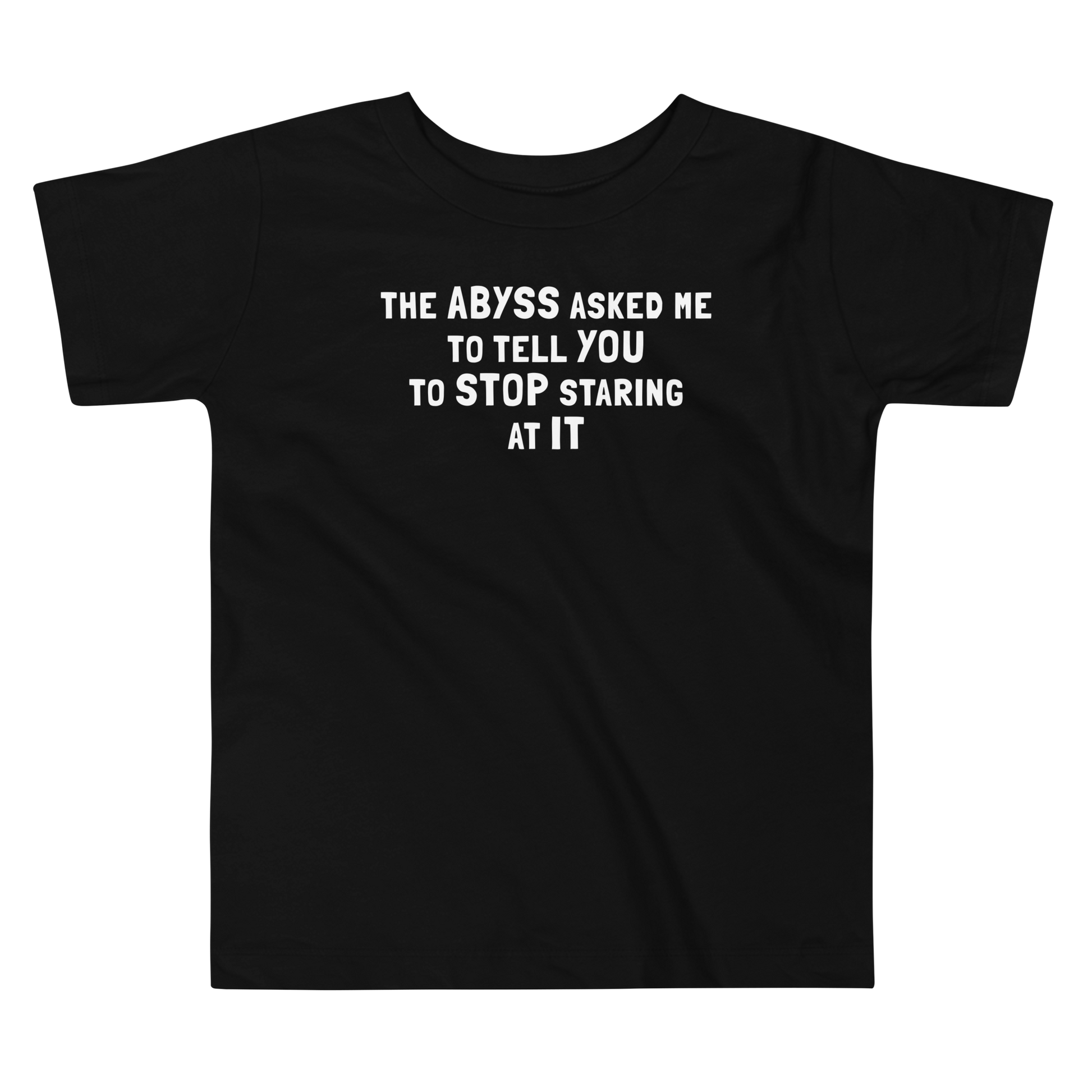 "The Abyss asked me to tell you to stop staring at it" printed on a black toddler short sleeve tee laying on a flat surface