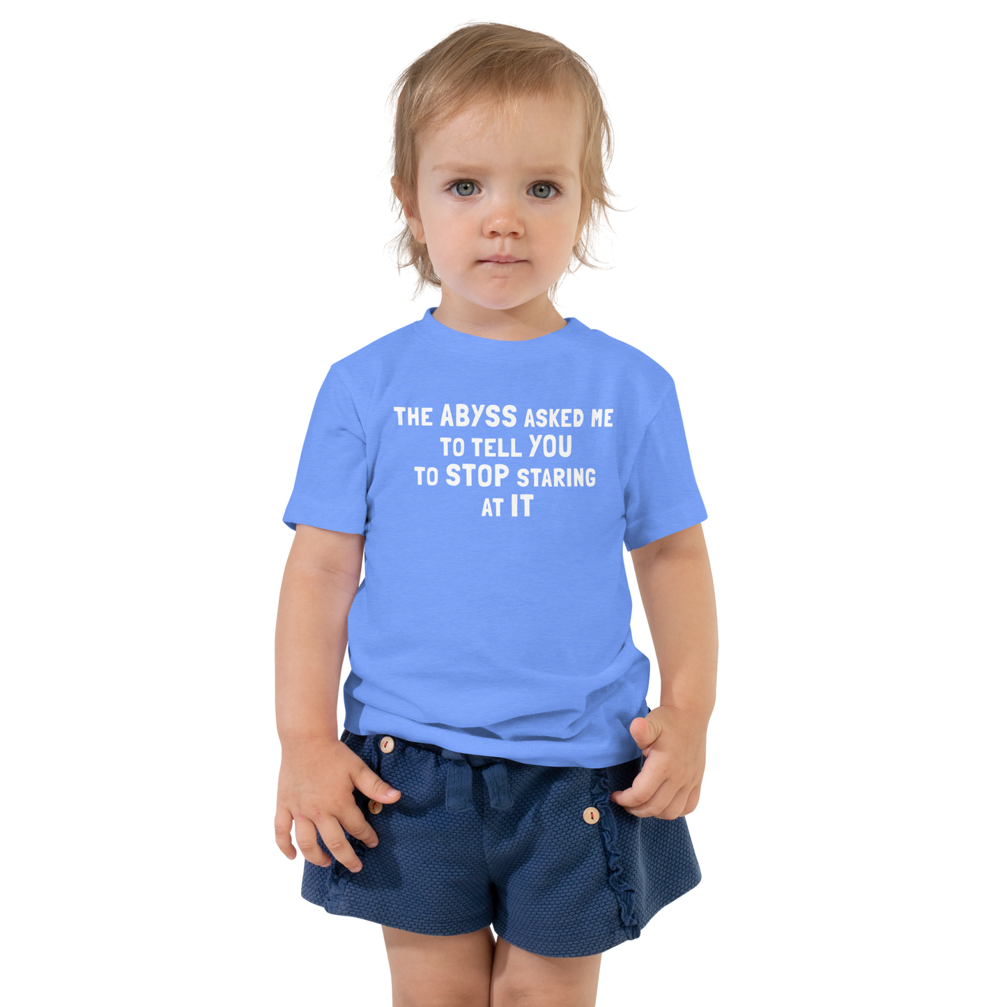 "The Abyss asked me to tell you to stop staring at it" printed on a heather columbia blue toddler short sleeve tee worn by a female