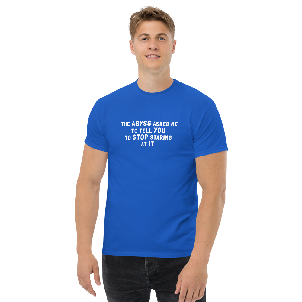 "The Abyss asked me to tell you to stop staring at it" printed on a royal unisex classic tee worn by a male