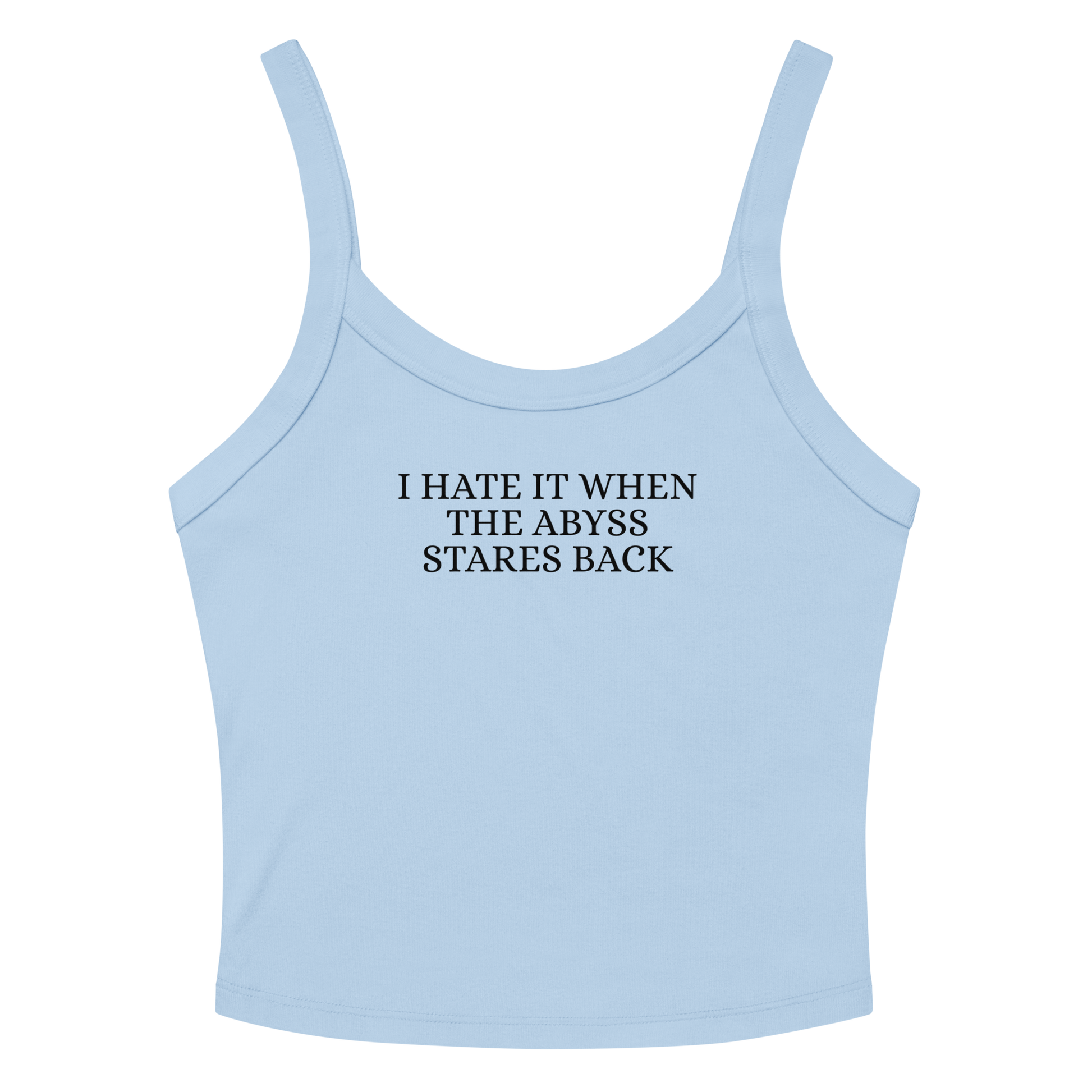"I hate it when the abyss stares back" printed on a solid baby blue blend women's micro-rib tanktop laying on a flat surface amongst sunglasses and shorts