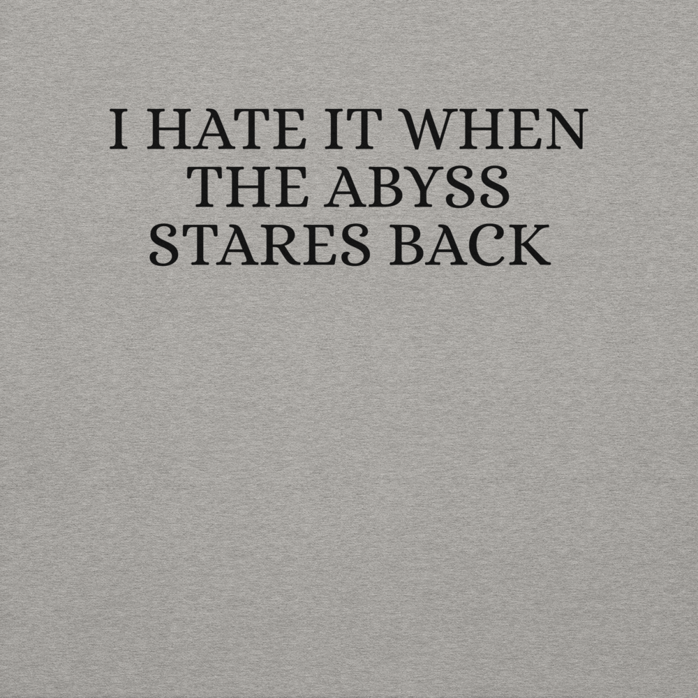 "I hate it when the abyss stares back" printed on a carbon grey background