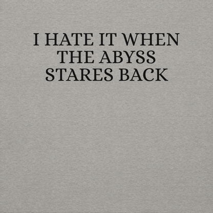 "I hate it when the abyss stares back" printed on a carbon grey background