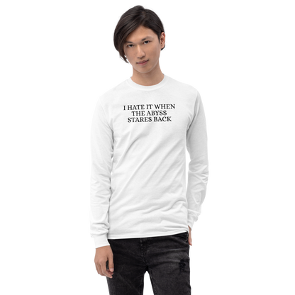 "I hate it when the abyss stares back" printed on a white men's long sleeve shirt worn by a male