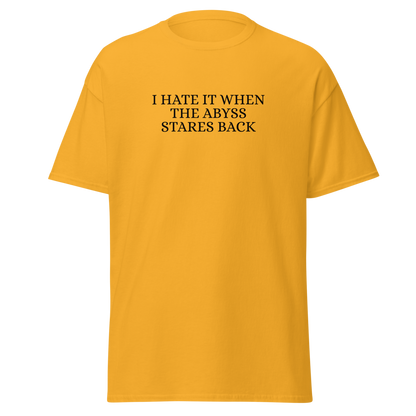 "I hate it when the abyss stares back" printed on a gold on an invisible body