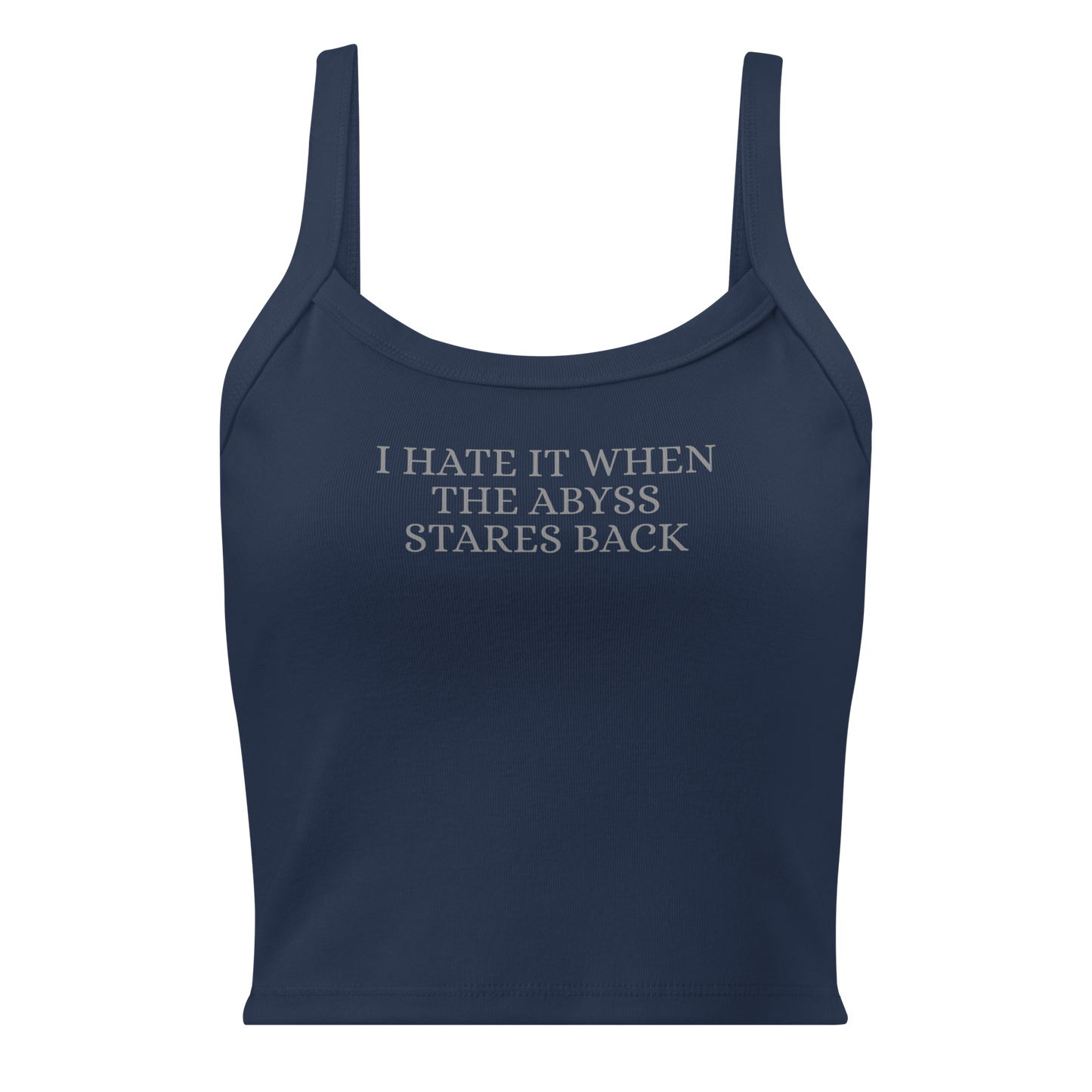 "I hate it when the abyss stares back" printed on a solid navy blend women's micro-rib tanktop laying on a flat surface