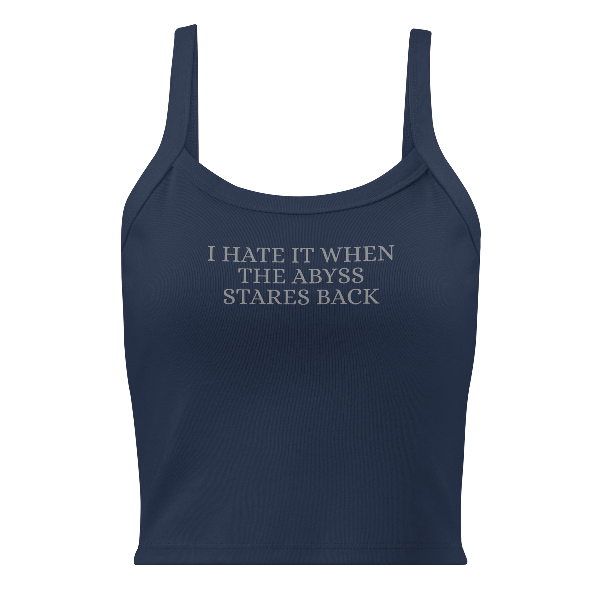"I hate it when the abyss stares back" printed on a solid navy blend women's micro-rib tanktop laying on a flat surface