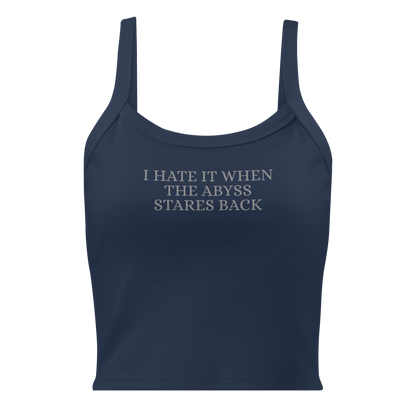 "I hate it when the abyss stares back" printed on a solid navy blend women's micro-rib tanktop laying on a flat surface