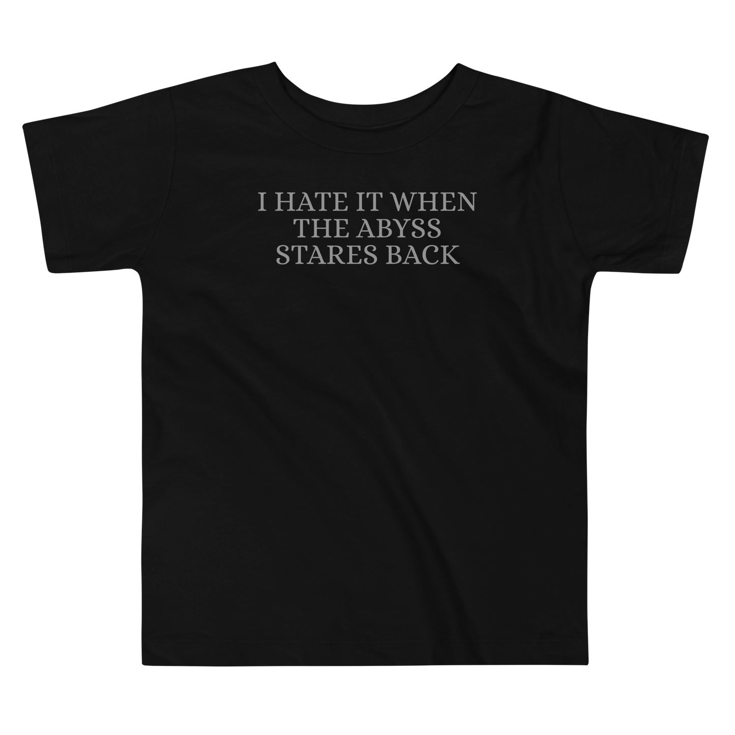 "I hate it when the abyss stares back" printed on a black toddler short sleeve tee laying on a flat surface