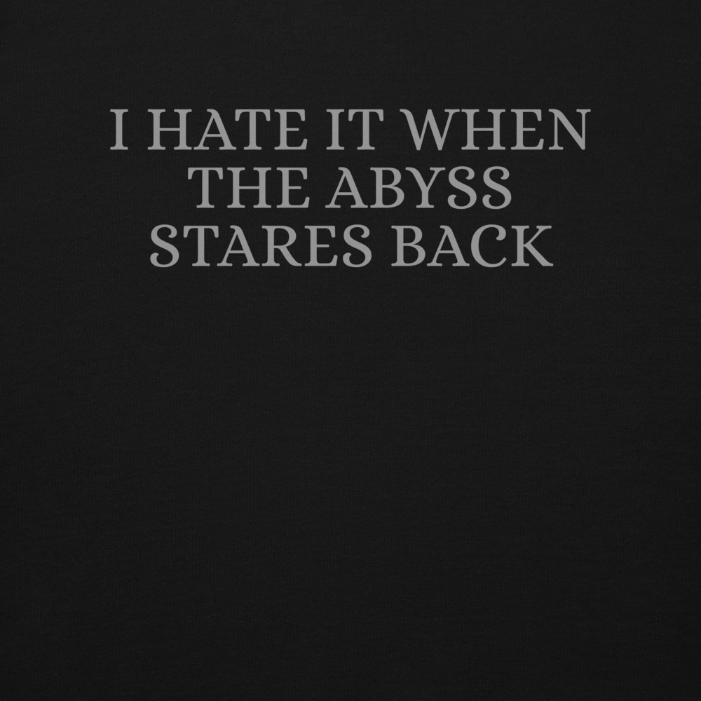 "I hate it when the abyss stares back" printed on a black background