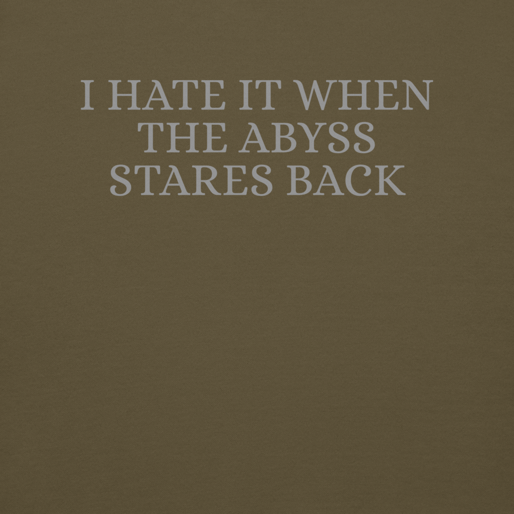 "I hate it when the abyss stares back" printed on a military green background