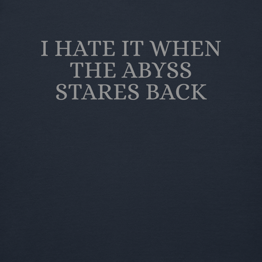 "I hate it when the abyss stares back" printed on a navy blazer background