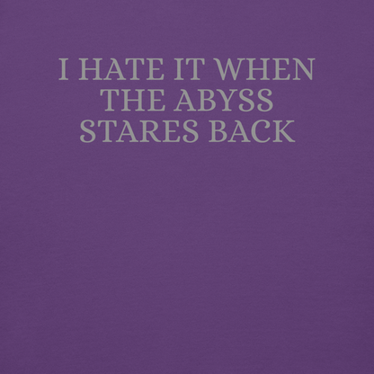 "I hate it when the abyss stares back" printed on a purple background