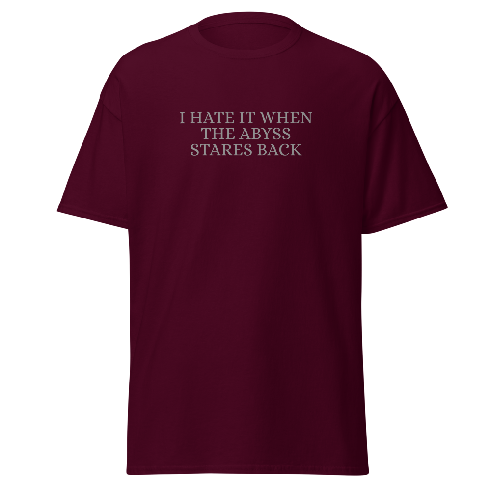 "I hate it when the abyss stares back" printed on a maroon on an invisible body