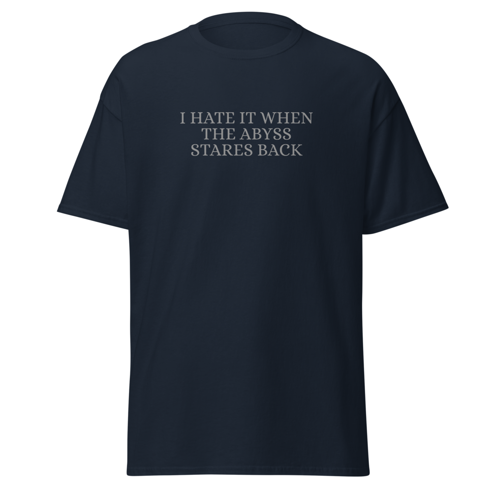 "I hate it when the abyss stares back" printed on a navy on an invisible body