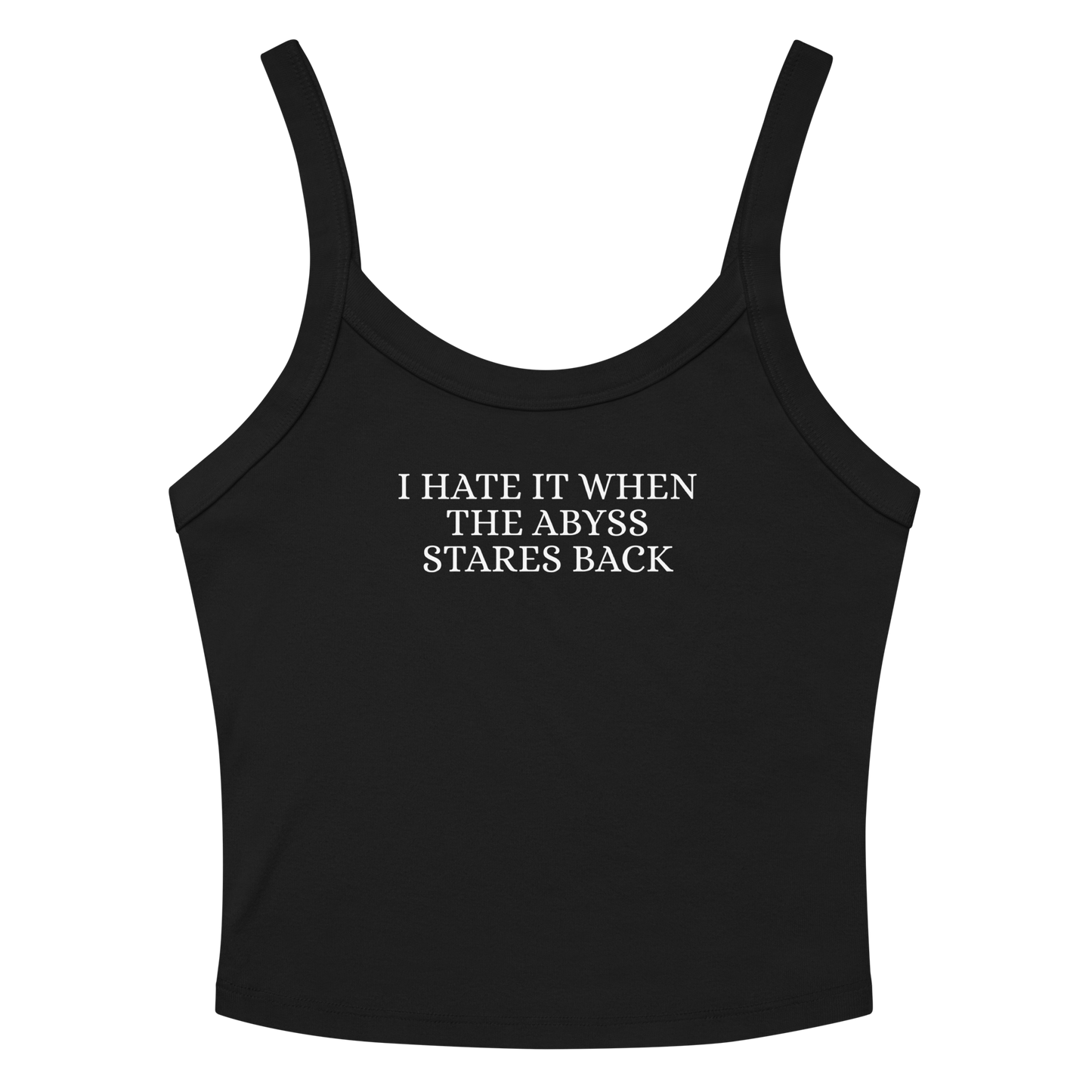 "I hate it when the abyss stares back" printed on a solid black blend women's micro-rib tanktop laying on a flat surface amongst sunglasses and shorts