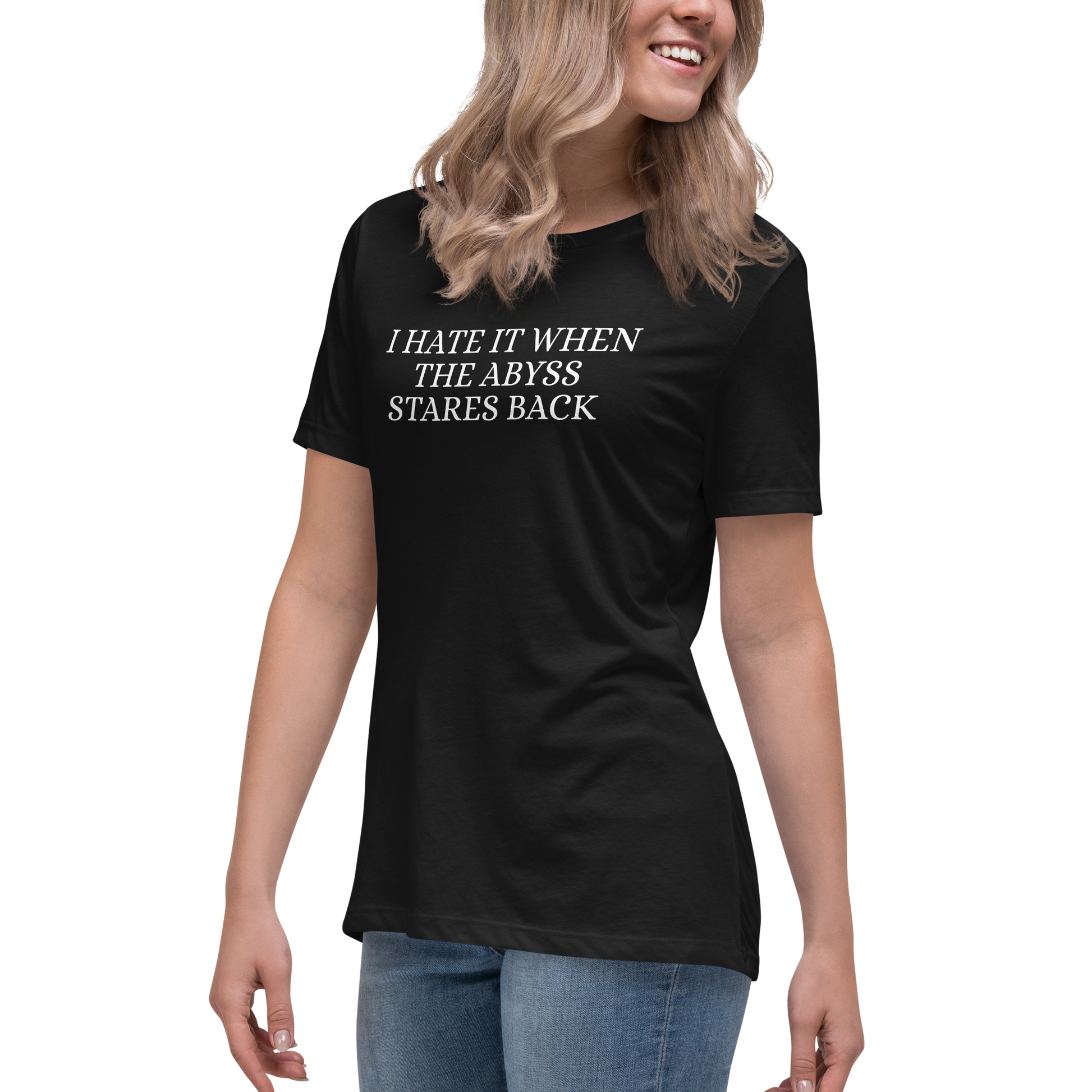 "I hate it when the abyss stares back" printed on a black women's relaxed t-shirt worn by a female
