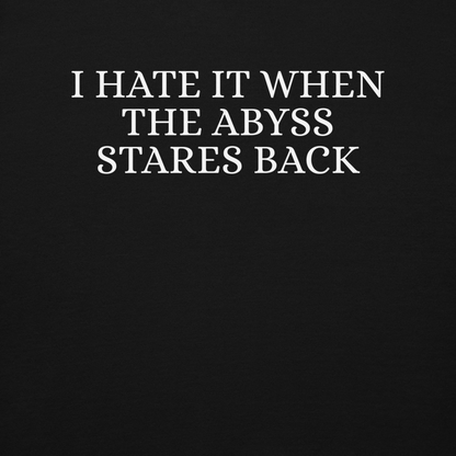"I hate it when the abyss stares back" printed on a black background