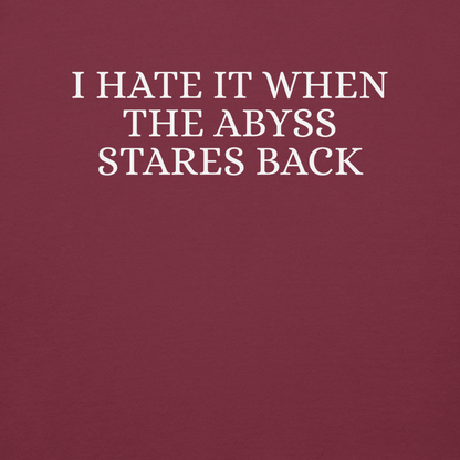 "I hate it when the abyss stares back" printed on a maroon background