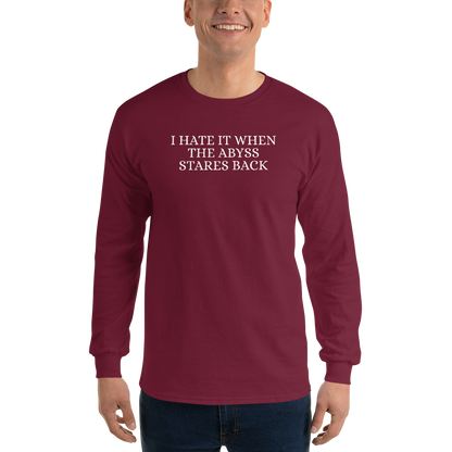 "I hate it when the abyss stares back" printed on a maroon men's long sleeve shirt worn by a male