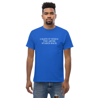 "I hate it when the abyss stares back" printed on a royal unisex classic tee worn by a male
