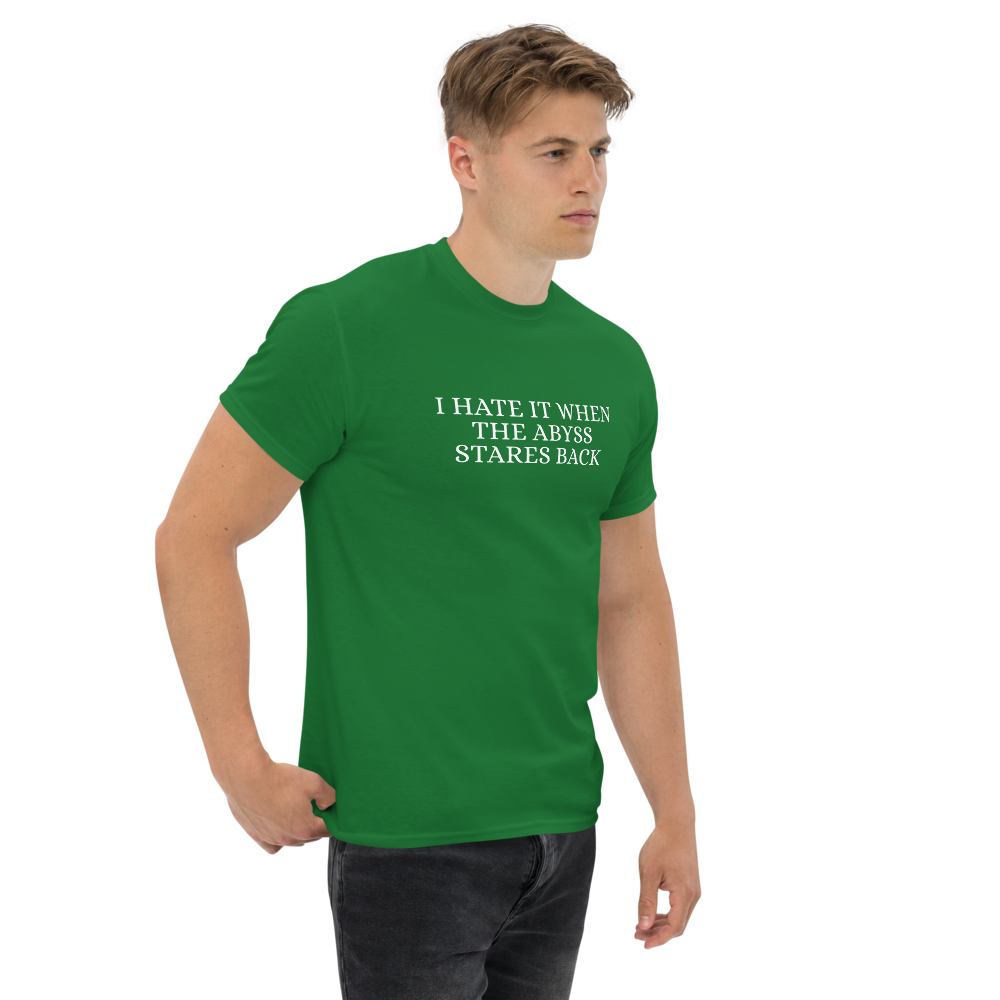 "I hate it when the abyss stares back" printed on a turf green unisex classic tee worn by a male