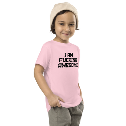 "I Am Fucking Awesome" printed on a pink toddler short sleeve tee worn by a male who is also wearing a knit cap