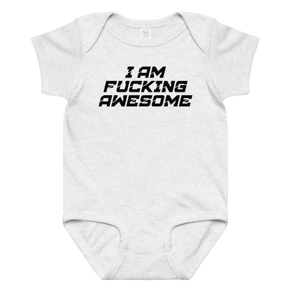 "I Am Fucking Awesome" printed on a ash baby jersey bodysuit laying on a flat surface amongst other clothes