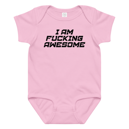 "I Am Fucking Awesome" printed on a pink baby jersey bodysuit laying on a flat surface amongst other clothes