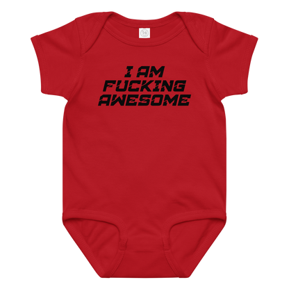 "I Am Fucking Awesome" printed on a red baby jersey bodysuit laying on a flat surface amongst other clothes
