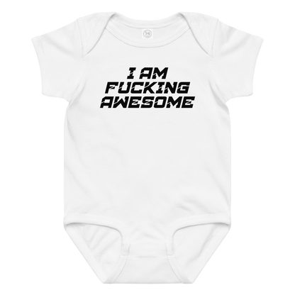 "I Am Fucking Awesome" printed on a white baby jersey bodysuit laying on a flat surface amongst other clothes