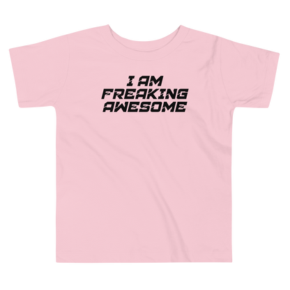 "I Am Freaking Awesome" printed on a pink toddler short sleeve tee laying on a flat surface
