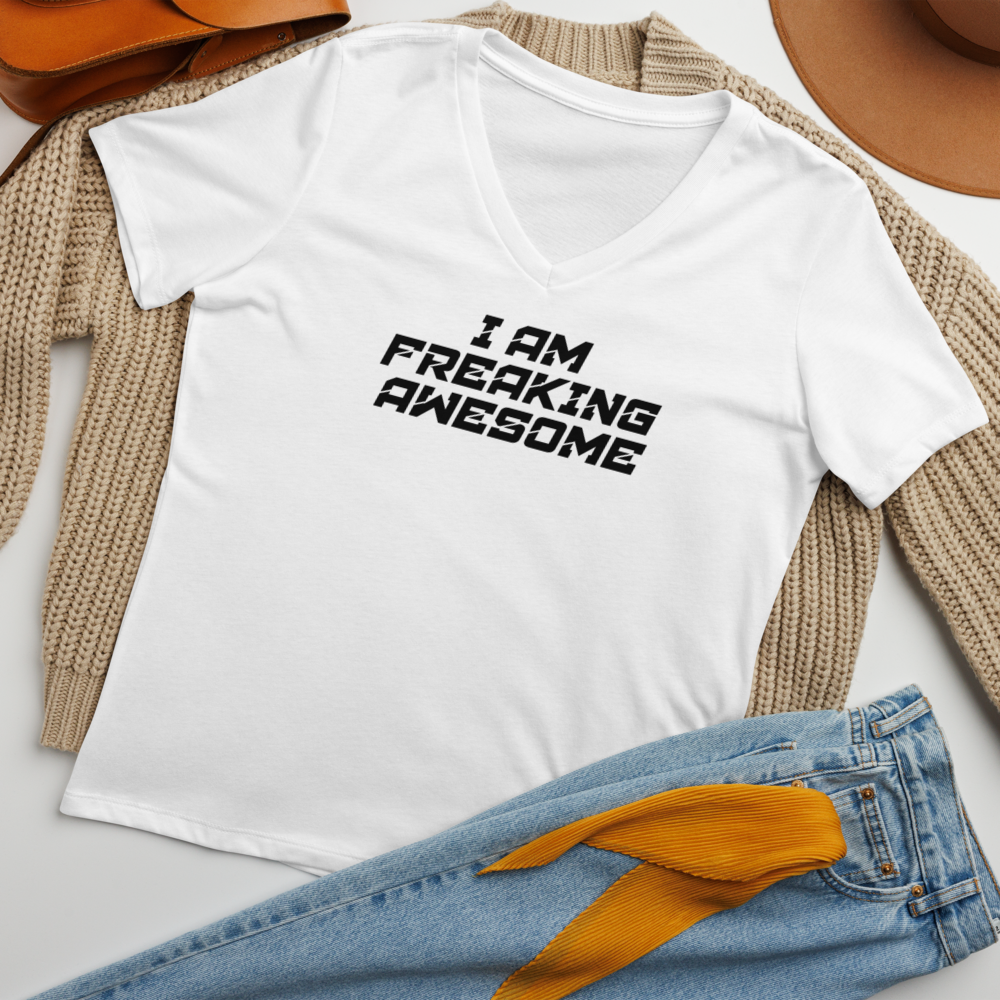 "I Am Freaking Awesome" printed on a solid white blend women's relaxed v-neck t-shirt laying on a flat surface amongst other clothes