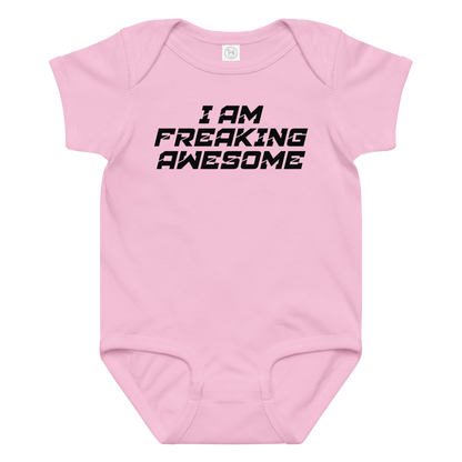 "I Am Freaking Awesome" printed on a pink baby jersey bodysuit laying on a flat surface amongst other clothes