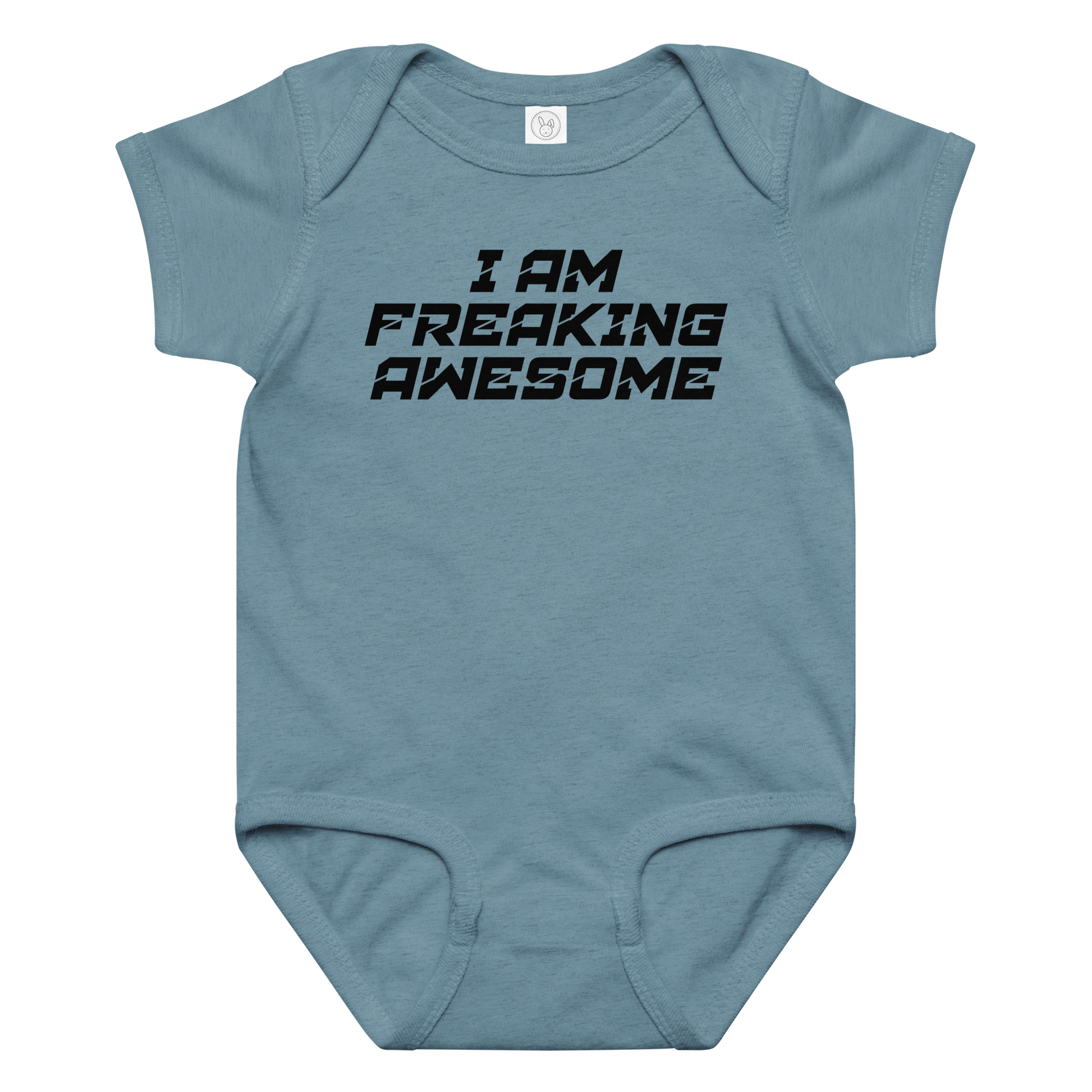 "I Am Freaking Awesome" printed on a vintage indigo baby jersey bodysuit laying on a flat surface amongst other clothes